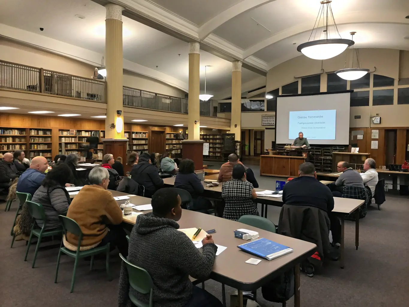 A diverse group of community members participating in a workshop, learning about local history and traditions, facilitated by ASSOC DES PAYS DU CEZALLIER.